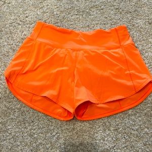 Highlight orange Lulu speed up shorts